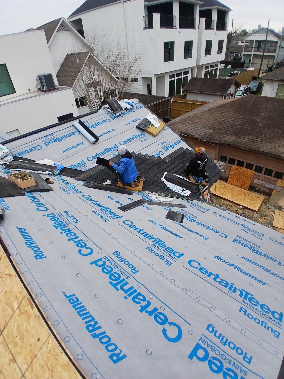 Team installing shingles